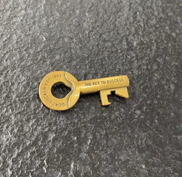 Gold key with "The Key To Success" engraved.