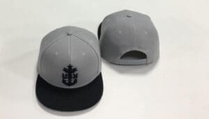 A pair of hats with the logo of a ship on them.