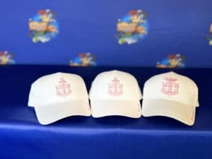 Three white hats with a red anchor on them.