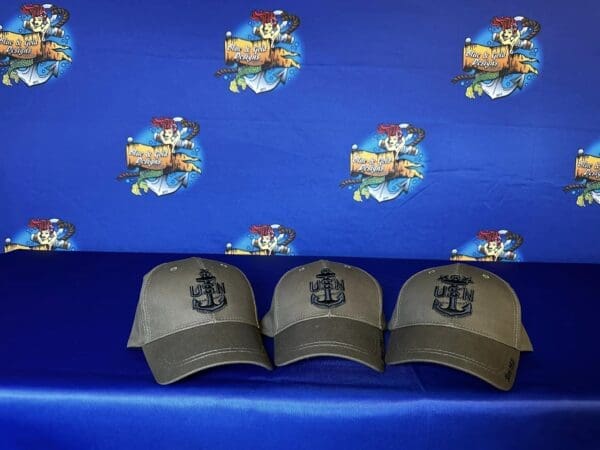 Three hats are sitting on a blue bench.