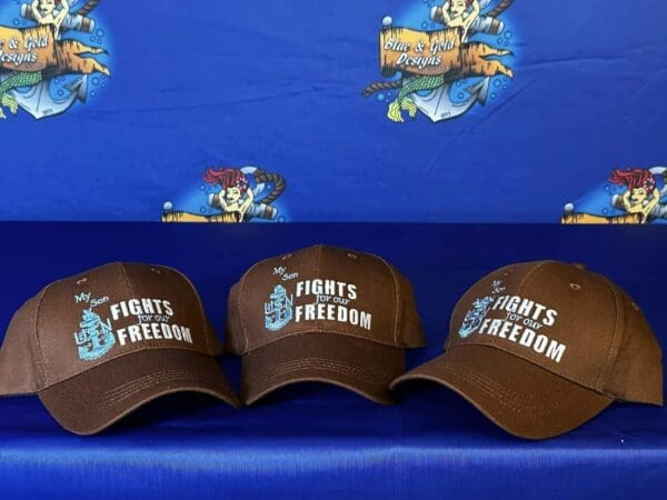 Three hats are sitting on a blue bench.