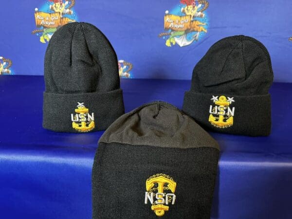 Three hats with the letters usn on them.